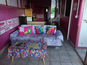 a living room with a couch and a table at CHEZ ALIZHIA in Nuku Hiva