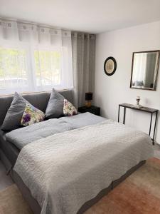 a bedroom with a bed and a clock on the wall at Apartment Prinz Luis in Owingen