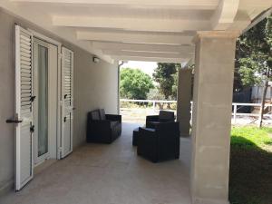 a patio with chairs and an open door at Casa via maucini in Pachino