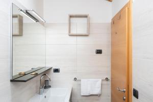 a bathroom with a sink and a mirror at Césa Marta in Canazei +9 photos