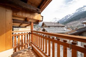 a view from the balcony of a wooden house at Césa Marta in Canazei