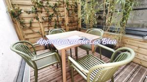 an outdoor table and chairs on a patio at La Maison de l'horloge in Bagnères-de-Bigorre