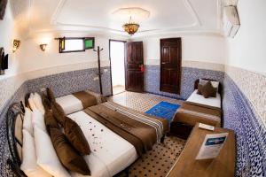 a bedroom with two beds in a room at Dar Amireal Fez in Fez