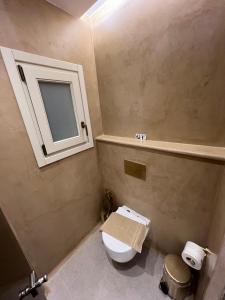 a bathroom with a toilet and a sink and a mirror at Pyrgianos Suites - Private Jacuzzi in Glinado Naxos