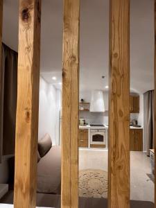 a kitchen with wooden columns in a room at Pyrgianos Suites - Private Jacuzzi in Glinado Naxos