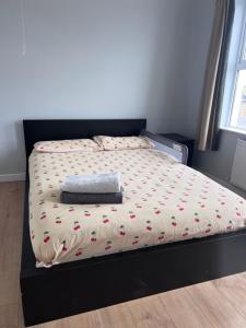 a bed with a comforter and a pillow on it at Cheerful cottage 3-bedroom in Drehidnaraga Bridge