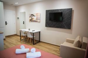a living room with a couch and a table with towels at Hersol Skyline in Durrës
