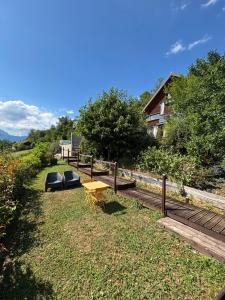 a picnic table and benches in a yard at Gîtes Le Cerf de Belledonne in Sainte-Agnès