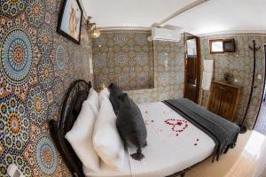a bedroom with a bed with pillows on it at Dar Amireal Fez in Fez +88 photos