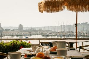 a table with food on it with a view of a harbor at Le Thalassa Hôtel & Spa in Camaret-sur-Mer