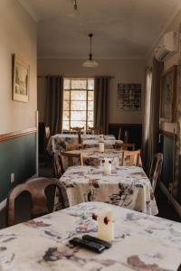 a dining room with tables and chairs and a room with tables at Garingboom Guest Farm in Groot-Suurfontein