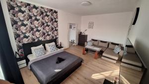 a living room with a bed and a couch at Apartament Kalwaria Piekary in Piekary Śląskie