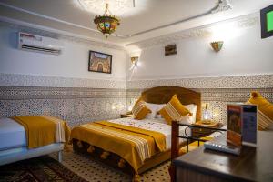 a bedroom with a bed and a table in it at Dar Amireal Fez in Fez