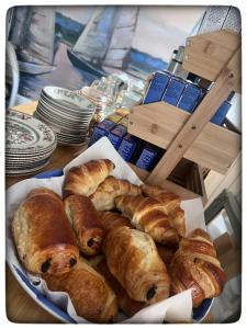 a plate of croissants and pastries on a table at Britmead Guesthouse in West Bay