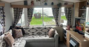 a living room with a couch and a large window at Gemini in Heysham