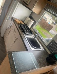 a kitchen with a sink and a keyboard on a counter at Gemini in Heysham