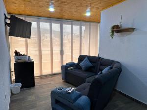 a living room with a couch and a chair at Apartamentos Paipa Boyacá "Las Quintas" Pisos 2 y 3 in Paipa