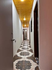 a hallway with a tile floor and a ceiling at Apartamentos Paipa Boyacá "Las Quintas" Pisos 2 y 3 in Paipa