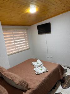 a bedroom with a bed with towels on it at Apartamentos Paipa Boyacá "Las Quintas" Pisos 2 y 3 in Paipa +29 photos