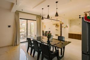 a kitchen and dining room with a table and chairs at The Marigold Villa in Pune