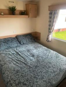 a bed in a bedroom with a window at Gemini in Heysham