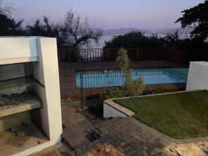 a view of a swimming pool from a house at Mafofolozi Lodge in Hartbeespoort