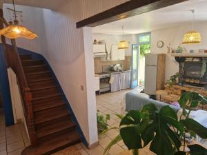 a living room with a staircase and a kitchen at COTTAGE - Utopy Hostel in Capbreton +20 photos
