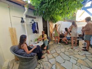 a group of people sitting around a table in a room at COTTAGE - Utopy Hostel in Capbreton