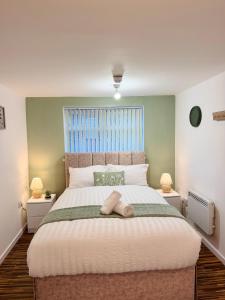 a bedroom with a large bed with two night stands at Brit Rooms Manchester in Manchester