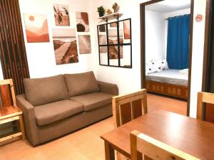 a living room with a couch and a table at Joi's One Oasis Condo Near Limketkai Mall in Cagayan de Oro