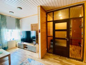 a living room with a door and a room with at Kauba 6-6 Apartment in Kuressaare