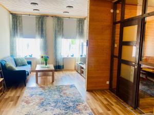 a living room with a couch and a table at Kauba 6-6 Apartment in Kuressaare