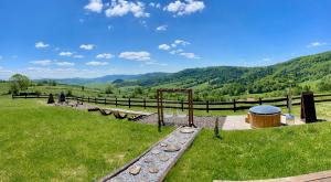 a park with benches and a view of a mountain at Chata Rajski Widok in Baligród