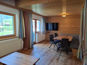 a dining room with a table and chairs at Appartment Sonnenkogel in Holzgau