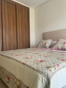a bedroom with a bed with a wooden cabinet at Escapade à Sidi Rahal in Sidi Rahal +28 photos