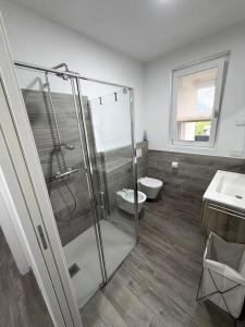 a bathroom with a shower and a toilet and a sink at Civico27-modern apartment in Sondrio in Sondrio +9 photos