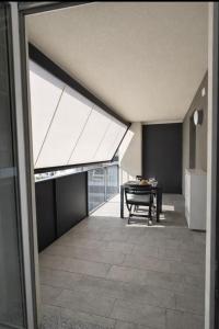 a dining room with a table and a ceiling with skylights at Civico27-modern apartment in Sondrio in Sondrio