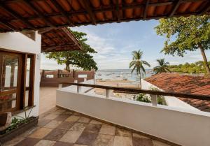a view of the beach from the balcony of a house at Casaboa Casarão Boutique Orla in Itacaré