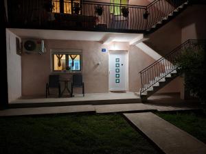 a house with a staircase and a door and a table at Apartman Jana in Žabljak