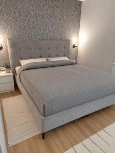 a bedroom with a large bed with a large headboard at Apartman Jana in Žabljak