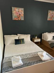 a bedroom with a large bed with towels on it at MARIALENA HOMe in Petropiyí