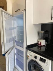a refrigerator with its door open in a kitchen at Appartement 2 chambres Martil in Martil