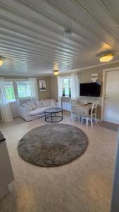 a large living room with a couch and a table at Semesterbostad Viksberg in Avesta