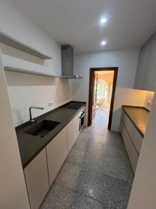 a kitchen with white cabinets and a sink at Casa Luis - Javea - Spanien in Jávea