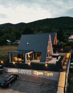 a house with a car parked in front of it at LUMA Lodge in Sadu