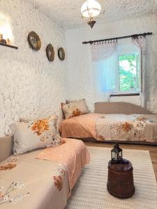 a bedroom with two beds and a window at Sailor's Rustic House in Virpazar