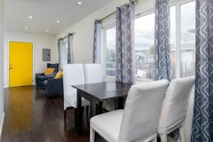 a dining room with a table and white chairs at SF City Inn free parking on site in Oakland