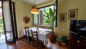 a dining room with a white table and chairs at Lesa Lake House in Lesa