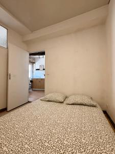 a bedroom with a large bed with two pillows at Le Cocon des pierres du Jaur in Saint-Pons-de-Thomières