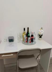 a white desk with bottles and glasses on it at Liam House - Stanza 2 in Limbiate